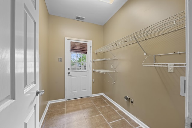 laundry room featuring baseboards, visible vents, laundry area, and tile patterned floors