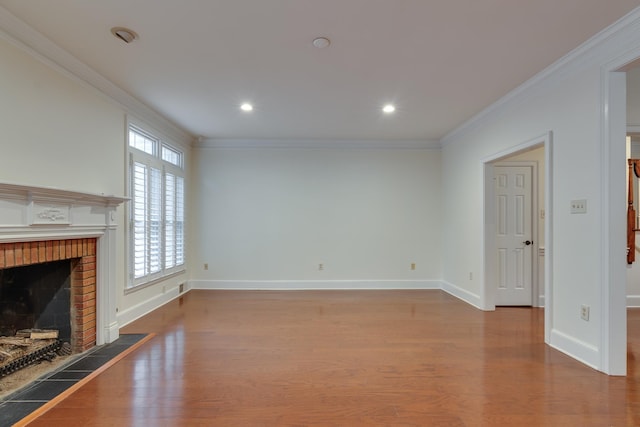 unfurnished living room featuring baseboards, crown molding, wood finished floors, and a fireplace
