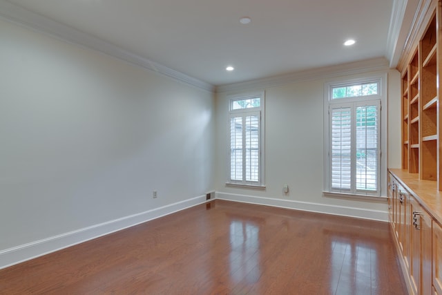 spare room featuring recessed lighting, crown molding, baseboards, and dark wood-style floors