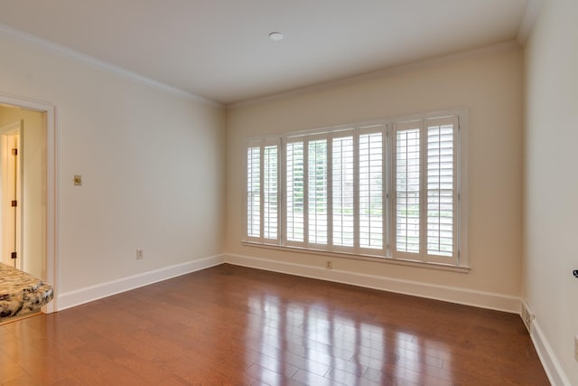 unfurnished room featuring baseboards, crown molding, and plenty of natural light