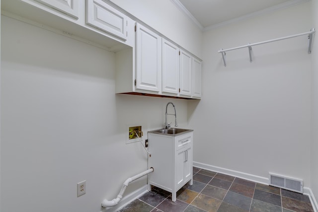 clothes washing area featuring a sink, visible vents, washer hookup, cabinet space, and ornamental molding