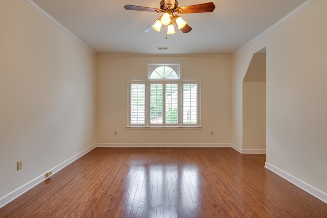 empty room with baseboards, a ceiling fan, visible vents, and dark wood finished floors