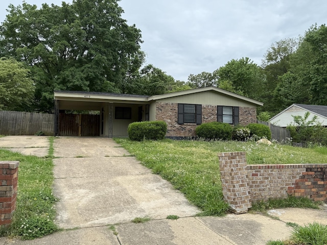 4279 University St, Memphis, TN 38127 - ranch-style home featuring brick siding, fence, a carport, and concrete driveway