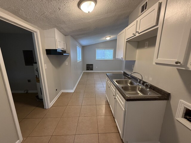 4279 University St, Memphis, TN 38127 - kitchen featuring under cabinet range hood, visible vents, light tile patterned floors, a sink, and a textured ceiling