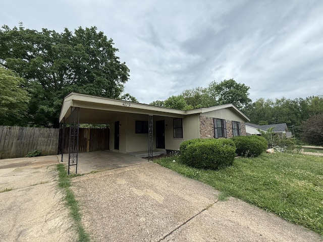 4279 University St, Memphis, TN 38127 - single story home featuring concrete driveway, fence, and a carport