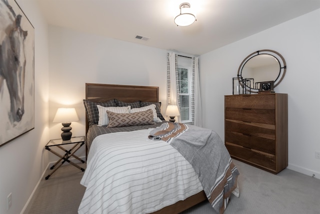 carpeted bedroom with baseboards and visible vents