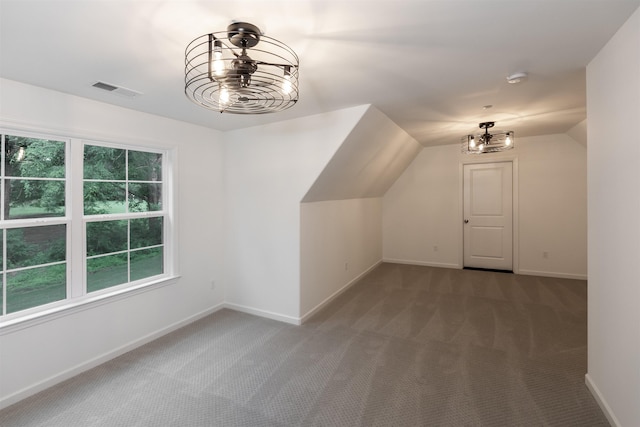 additional living space with baseboards, a notable chandelier, carpet flooring, and visible vents