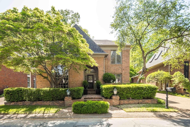 traditional-style home with brick siding