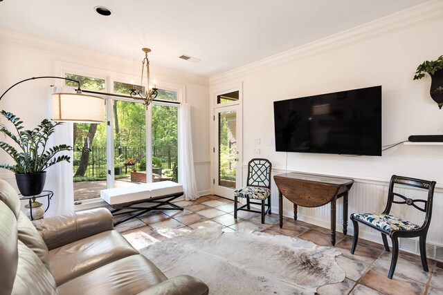 living area with visible vents, a chandelier, and crown molding
