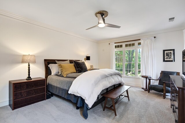 carpeted bedroom with baseboards, a ceiling fan, visible vents, and ornamental molding