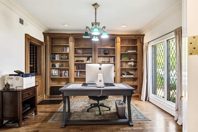 office with visible vents, dark wood-type flooring, and ornamental molding