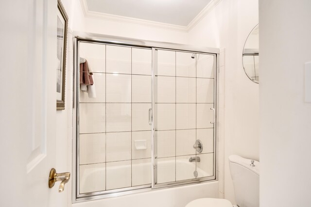 bathroom featuring toilet, crown molding, and combined bath / shower with glass door