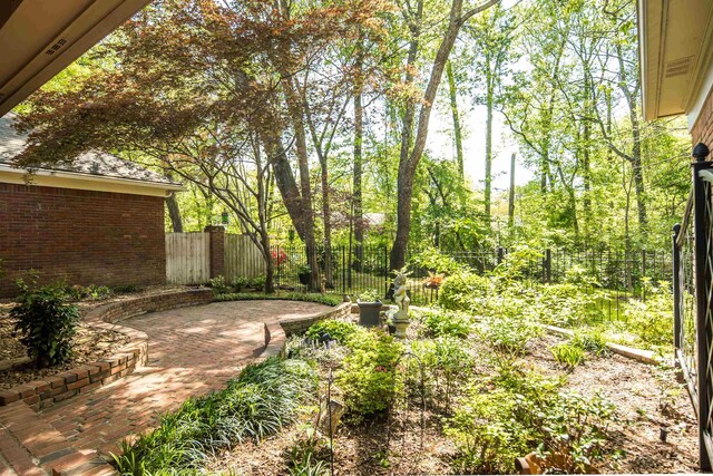 view of yard featuring fence and a patio area