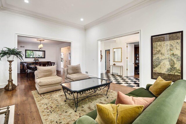 living area with recessed lighting, wood finished floors, baseboards, and ornamental molding