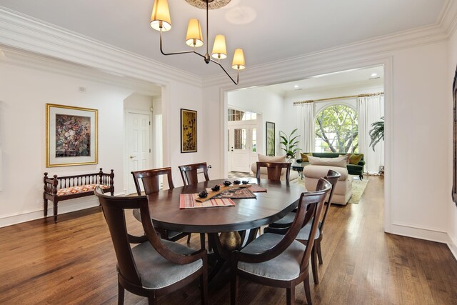 dining area featuring baseboards, dark wood-style flooring, and crown molding