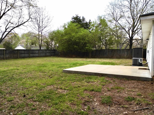 view of yard with a fenced backyard, central air condition unit, and a patio