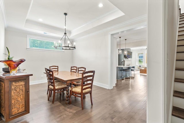 428 Catawba Valley Dr, Collierville, TN 38017 - dining room with baseboards, a chandelier, wood finished floors, stairs, and a raised ceiling