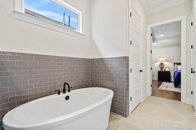 428 Catawba Valley Dr, Collierville, TN 38017 - ensuite bathroom featuring a soaking tub, tile walls, tile patterned flooring, crown molding, and ensuite bath