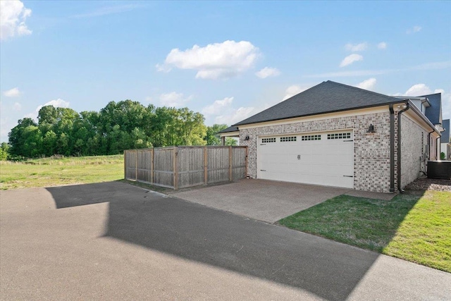 428 Catawba Valley Dr, Collierville, TN 38017 - view of home's exterior with fence, central AC, concrete driveway, a lawn, and brick siding