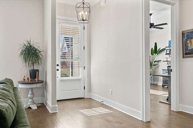 428 Catawba Valley Dr, Collierville, TN 38017 - entryway featuring baseboards, wood finished floors, and ceiling fan with notable chandelier