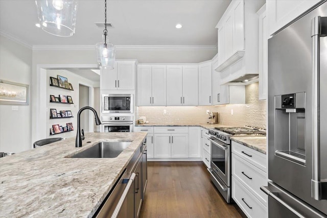 428 Catawba Valley Dr, Collierville, TN 38017 - kitchen featuring white cabinets, a sink, premium appliances, light stone counters, and crown molding