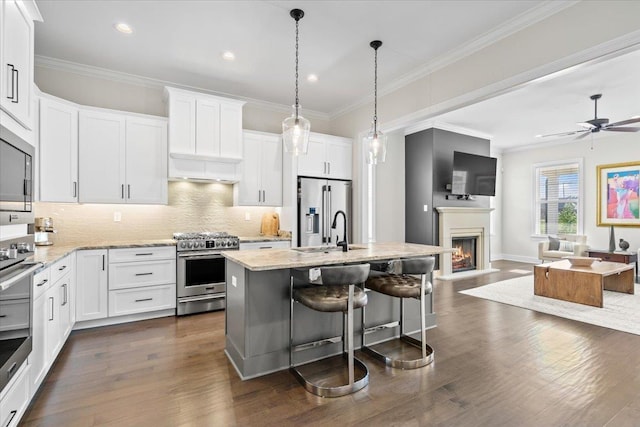 428 Catawba Valley Dr, Collierville, TN 38017 - kitchen with decorative backsplash, stainless steel appliances, white cabinets, and open floor plan