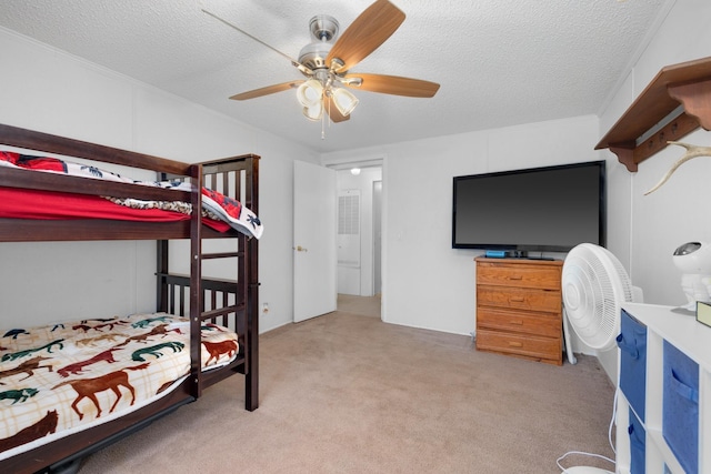 bedroom featuring a ceiling fan, carpet flooring, and a textured ceiling