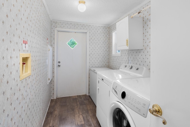 clothes washing area featuring independent washer and dryer, dark wood-style flooring, ornamental molding, and laundry area