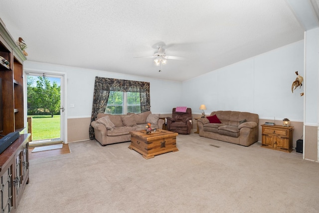 living room featuring a ceiling fan, carpet floors, and a healthy amount of sunlight