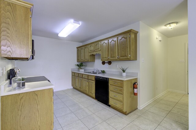kitchen featuring light tile patterned floors, light countertops, a sink, and black dishwasher