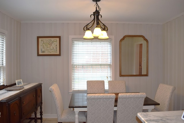 dining space featuring crown molding