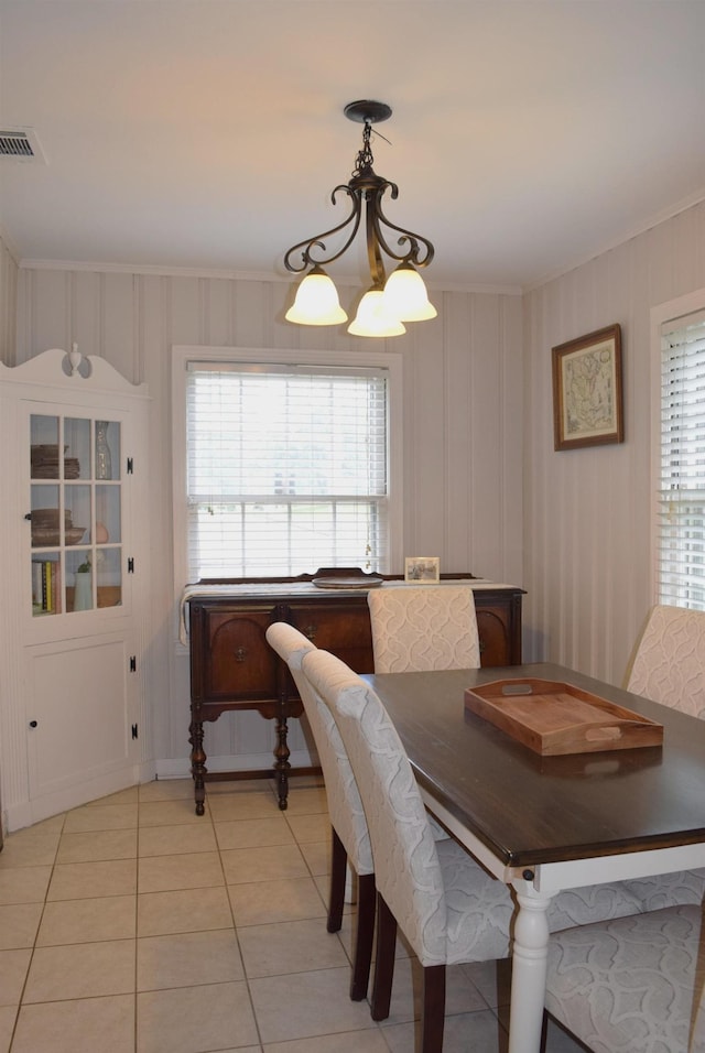 dining room with ornamental molding, a chandelier, visible vents, and light tile patterned floors