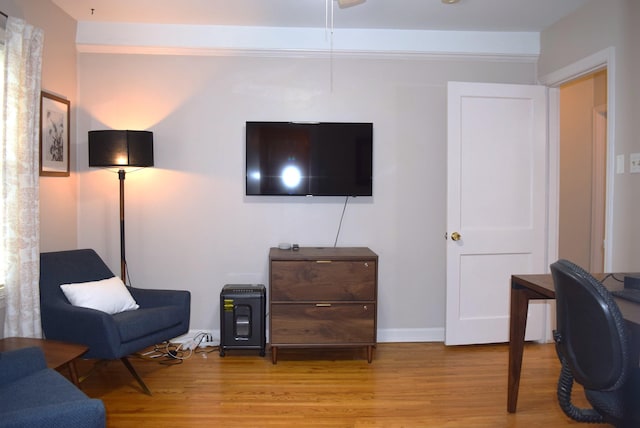interior space featuring baseboards and wood finished floors