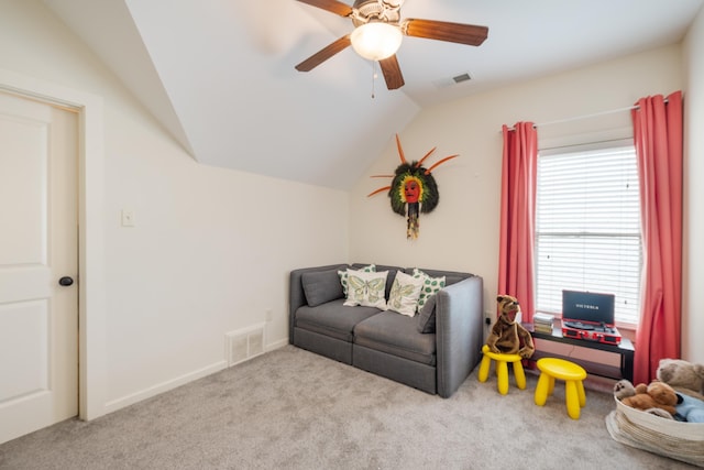 sitting room with vaulted ceiling, a healthy amount of sunlight, carpet flooring, and visible vents