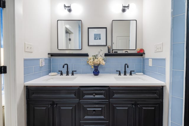 full bathroom with decorative backsplash, a sink, and double vanity