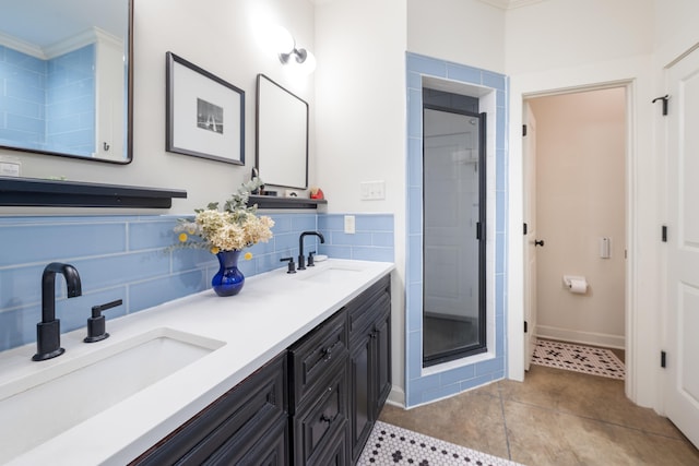 full bathroom featuring tile patterned floors, a sink, double vanity, and a stall shower