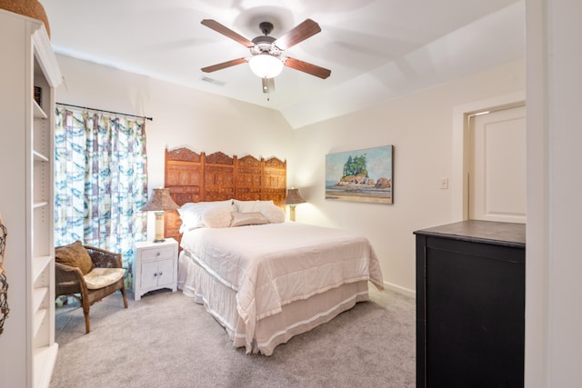 bedroom with light colored carpet, ceiling fan, lofted ceiling, and visible vents