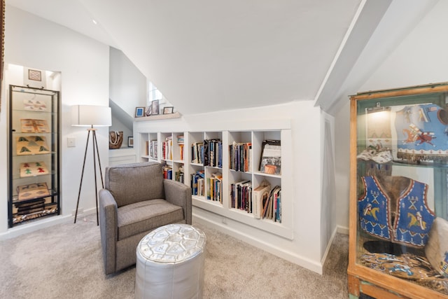 living area with carpet floors, lofted ceiling, and baseboards
