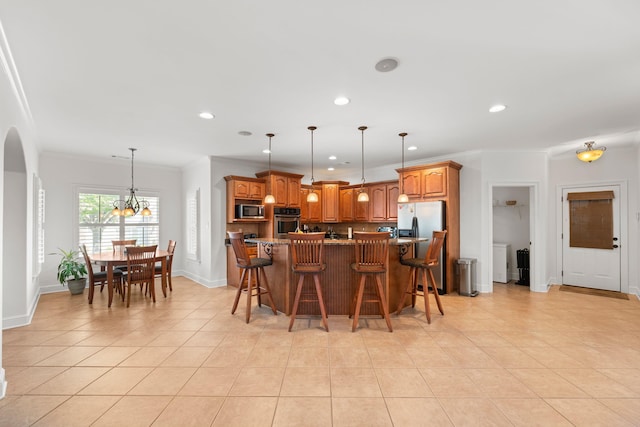 93 Eagle Glade Cv, Cordova, TN 38018 - kitchen with appliances with stainless steel finishes, arched walkways, light tile patterned flooring, recessed lighting, and ornamental molding