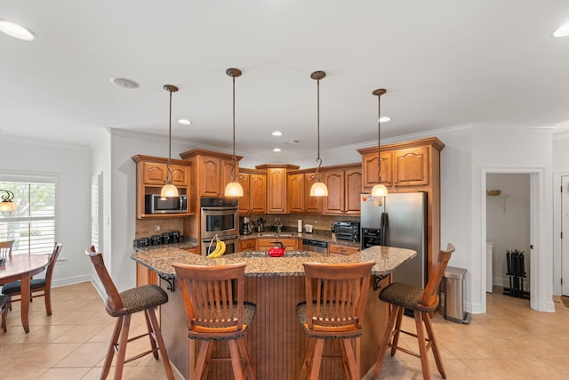 93 Eagle Glade Cv, Cordova, TN 38018 - kitchen featuring crown molding, stainless steel appliances, light tile patterned flooring, brown cabinetry, and backsplash