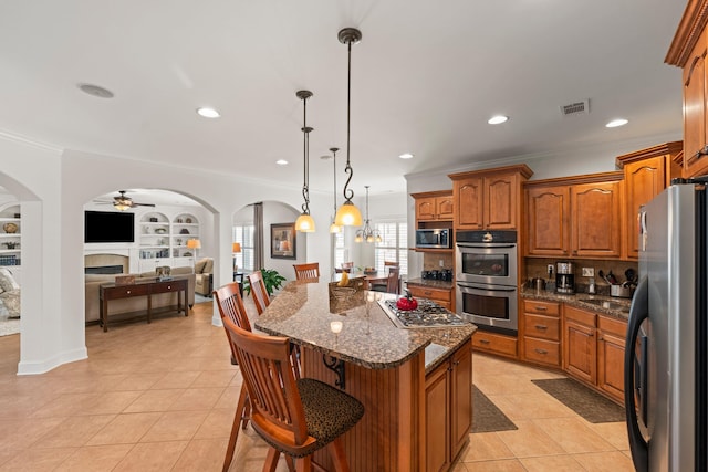 93 Eagle Glade Cv, Cordova, TN 38018 - kitchen featuring light tile patterned floors, appliances with stainless steel finishes, visible vents, open floor plan, and crown molding