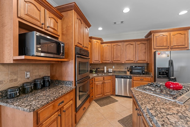 93 Eagle Glade Cv, Cordova, TN 38018 - kitchen with brown cabinets, light tile patterned floors, visible vents, and stainless steel appliances