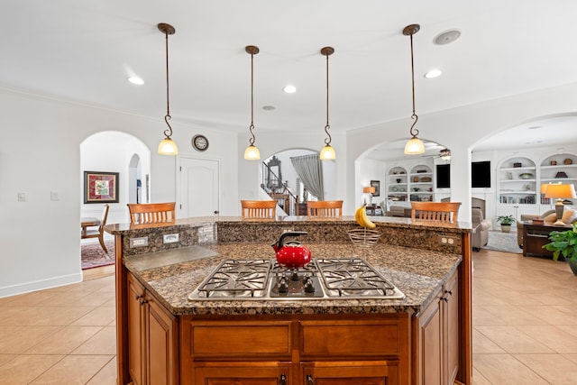 93 Eagle Glade Cv, Cordova, TN 38018 - kitchen featuring light tile patterned floors, stainless steel gas stovetop, ornamental molding, and arched walkways