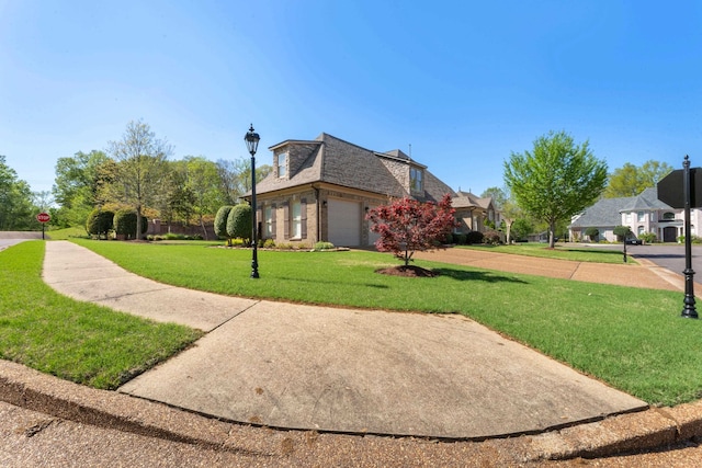 93 Eagle Glade Cv, Cordova, TN 38018 - view of property exterior featuring a lawn, a shingled roof, and brick siding