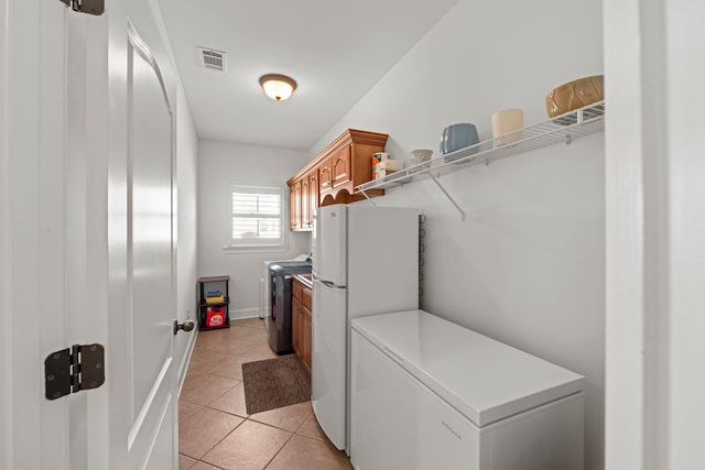 93 Eagle Glade Cv, Cordova, TN 38018 - clothes washing area with light tile patterned flooring, visible vents, baseboards, and washing machine and dryer