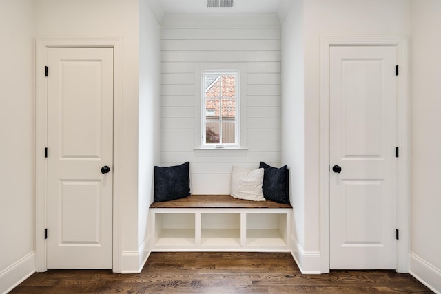 mudroom featuring visible vents, baseboards, and dark wood finished floors