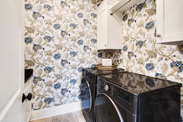 laundry area with baseboards, wallpapered walls, cabinet space, and washer and clothes dryer