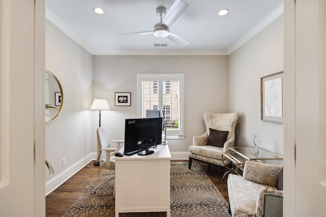 office space featuring dark wood-style floors, visible vents, ornamental molding, and a ceiling fan