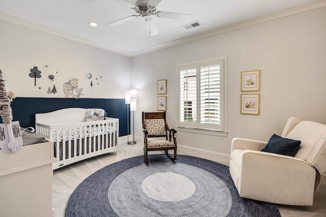 bedroom featuring visible vents, a nursery area, baseboards, recessed lighting, and a ceiling fan
