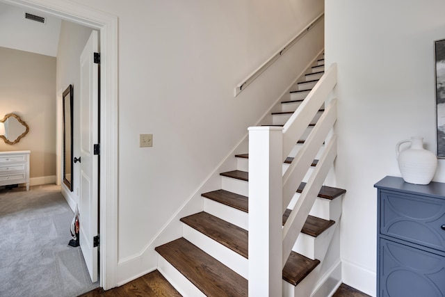 stairway featuring visible vents, carpet floors, and baseboards